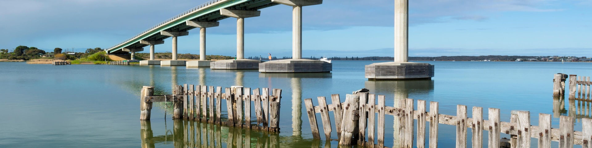 J0427B Reflected fence pylons and the bridge between Goolwa and Hindmarsh Island, South Australia. Part of the Fleurieu Peninsula.
