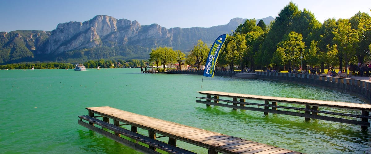 A lake with a wooden dock and a flag.