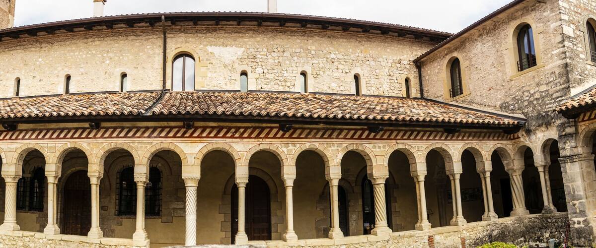 A historic building with a series of arches and a tiled roof.