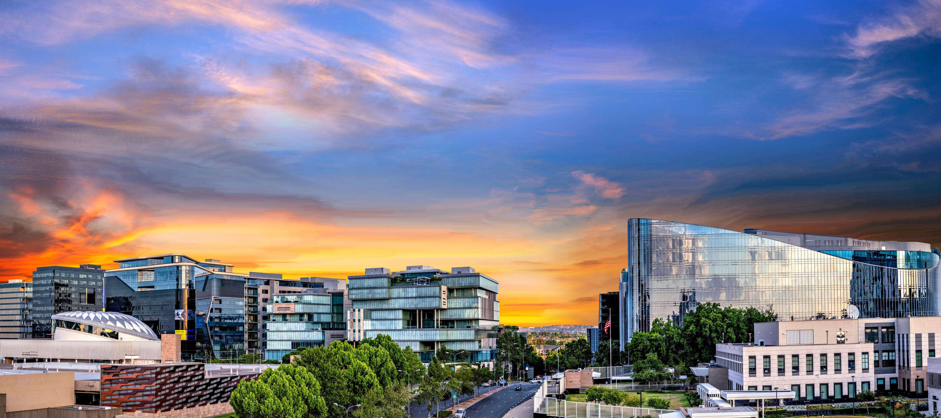 Panorama of Sandton City at sunset with colourful clouds