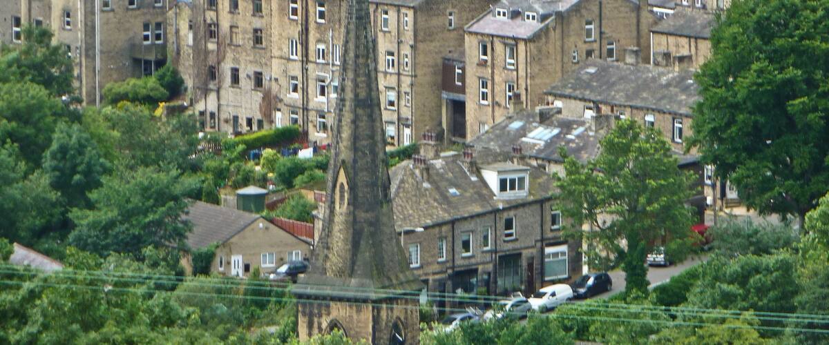 A town with historic stone buildings and a prominent church spire.