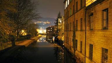 hebden bridge at night showing canal with the buildings of the town glowing in the distance