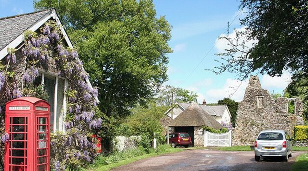 Dunkeswell: Abbey. With remains of the Cistercian abbey beyond the MPV. Beyond the white gates a path leads to the church of the Holy Trinity