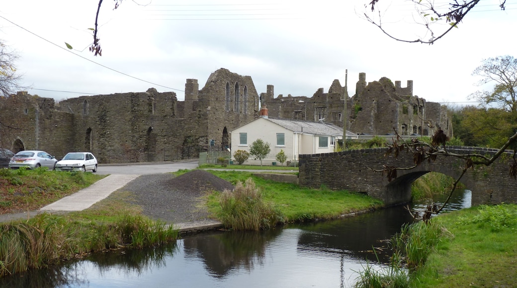 The ruins of the cistercian Neath Abbey, alongside a section of the Tennant Canal, in the Neath valley. On the right of the ruins is a ruined 17th century mansion built within the abbey ruins. The site was heavily industrialised in the 19th C, excavated in the 1920s, is now in the care of Cadw.