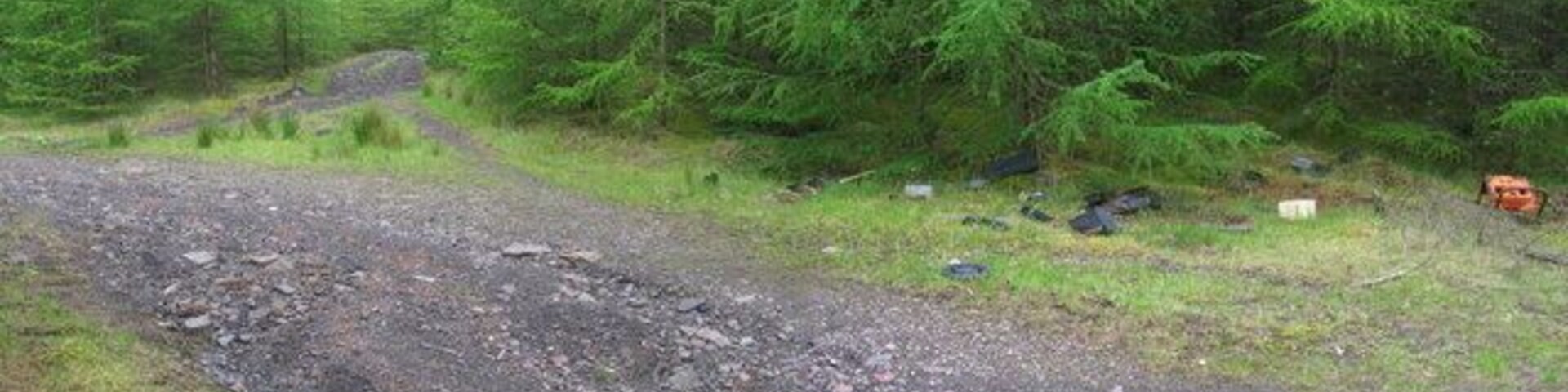 Dumped A sad fact about these forest tracks in reclaimed mining country is the detritus of modern life that is dumped all along them. Ahead is yet another complicated junction only partly marked on the 1:25000 OS map. I don't know what the orange thing used to be, but just behind me was a video-recorder, a couple of televisions, and a fridge-freezer. It is a shame.