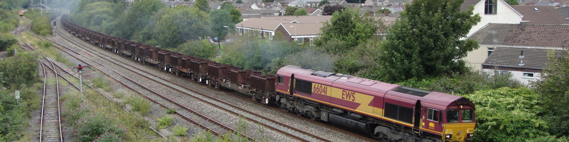 Freight train near Briton Ferry. An empty eastbound steel train heads away from Briton Ferry with locomotive No. 66041 in charge.