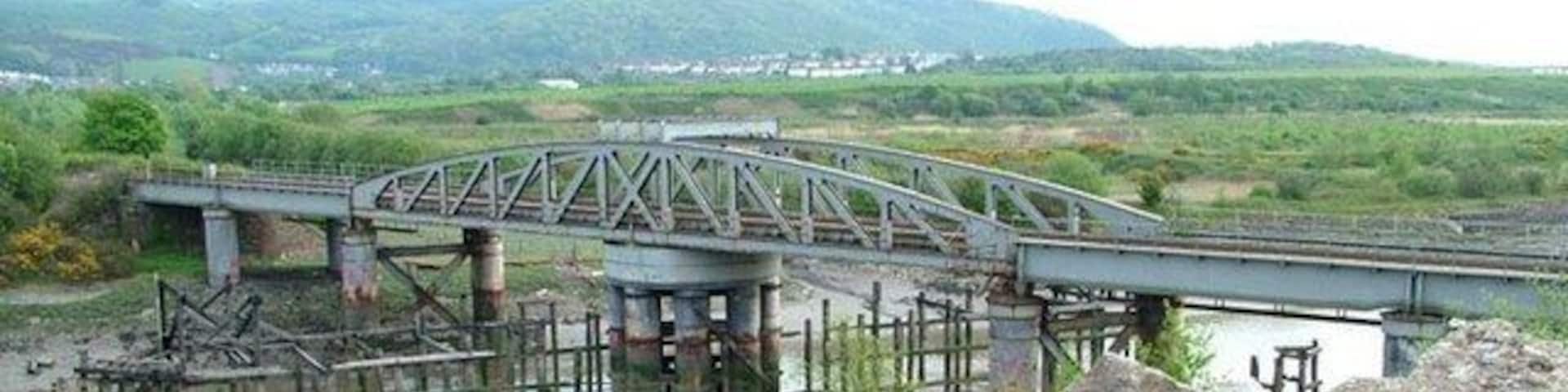 Neath Abbey Swing Bridge The Rhondda and Swansea Bay Railway Company opened its line in 1885, but could extend the line into Swansea until this swing bridge was completed in 1894. I am grateful to the owner of Derwent Construction and his plant operator Martin for their assistance in getting this image. This is one of over 1,450 movable bridges in the British Isles that I have identified for my historical website. www.movablebridges.org.uk