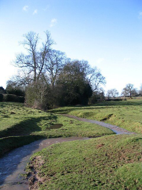 River Sherbourne Taken from the brick footbridge looking upstream. The river meanders between small bluffs. Taken after 2 days of snow followed by 1 day of rain.