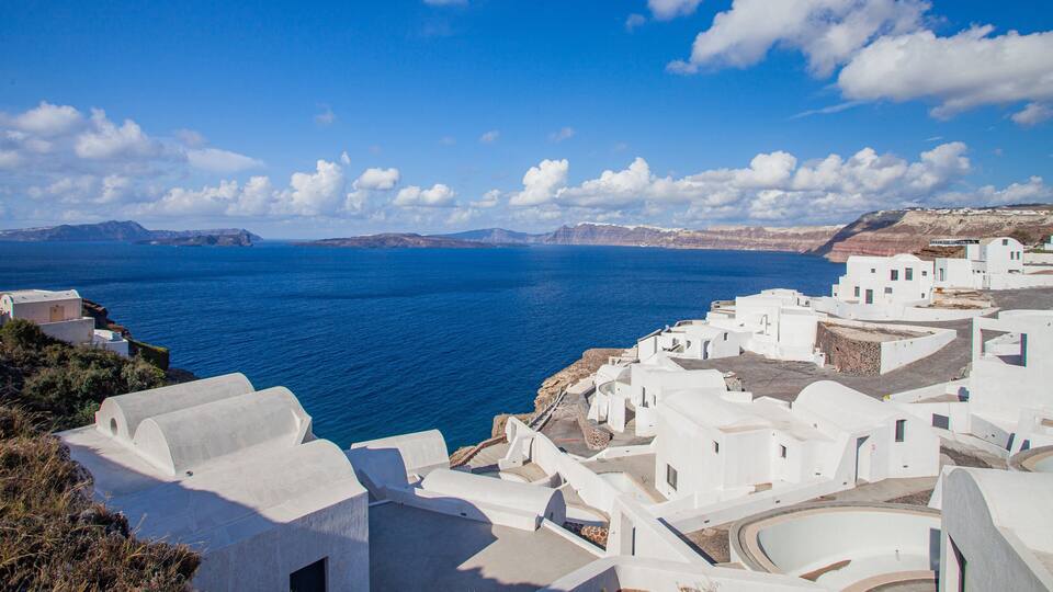 A coastal village with white buildings overlooking the sea.