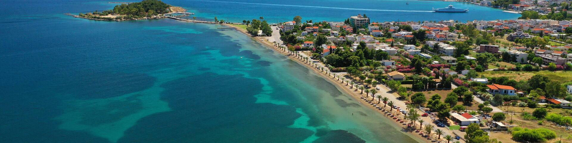 Aerial drone photo of famous island of dreams or Pesonisi connecting with small road with seaside fishing village of Eretria, Central Evia island, Greece