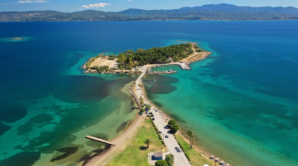 Aerial drone photo of famous island of dreams or Pesonisi connecting with small road with seaside fishing village of Eretria, Central Evia island, Greece