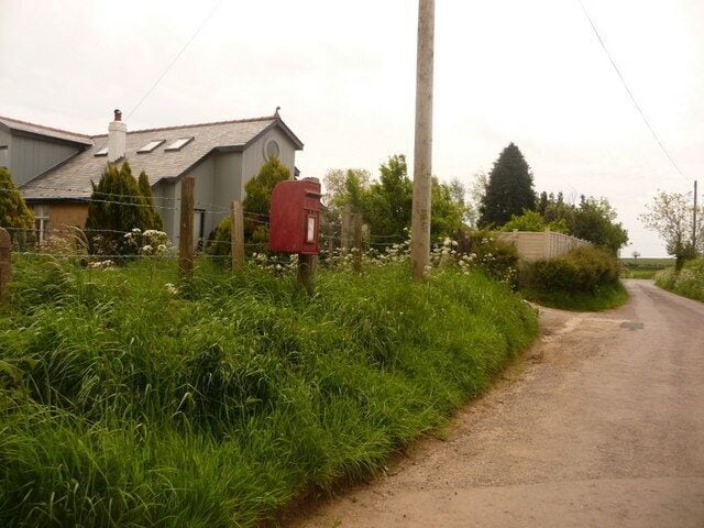 Doulting: postbox № BA3 143, Farringdon Lane A small postbox just north of the main road, whose junction we see in the distance. It is emptied at 11am on weekdays and at 9am on Saturdays.