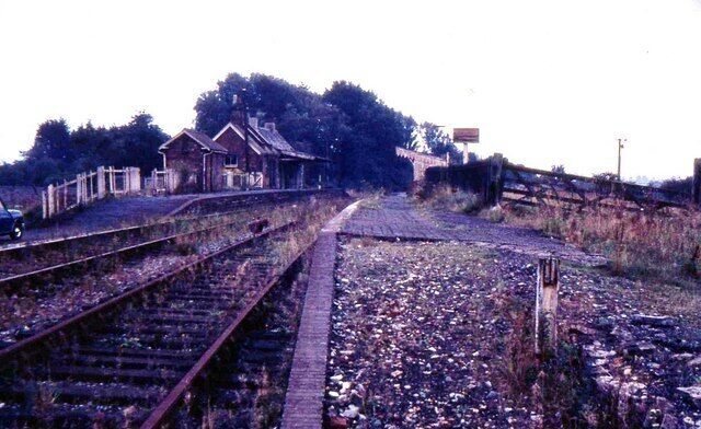 Railway tracks, a small building, and a fence.