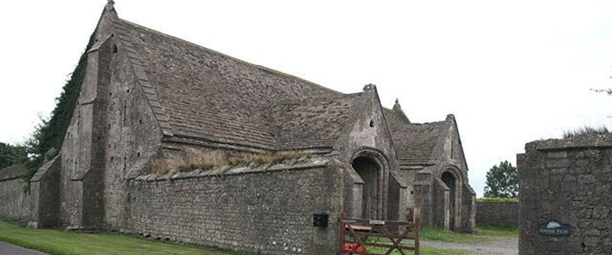 An old stone church with a gated entrance and a sign reading "St. Mary's Church."