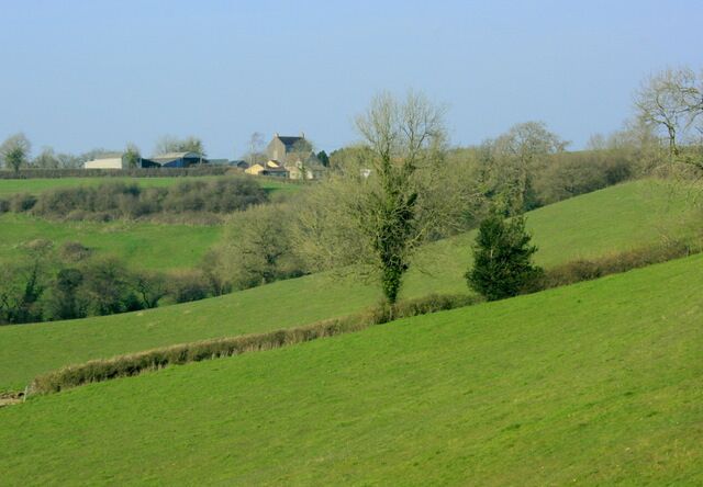 Eastcombe Farm from the A359 Looking across the valley formed by the headwaters of the River Alham.