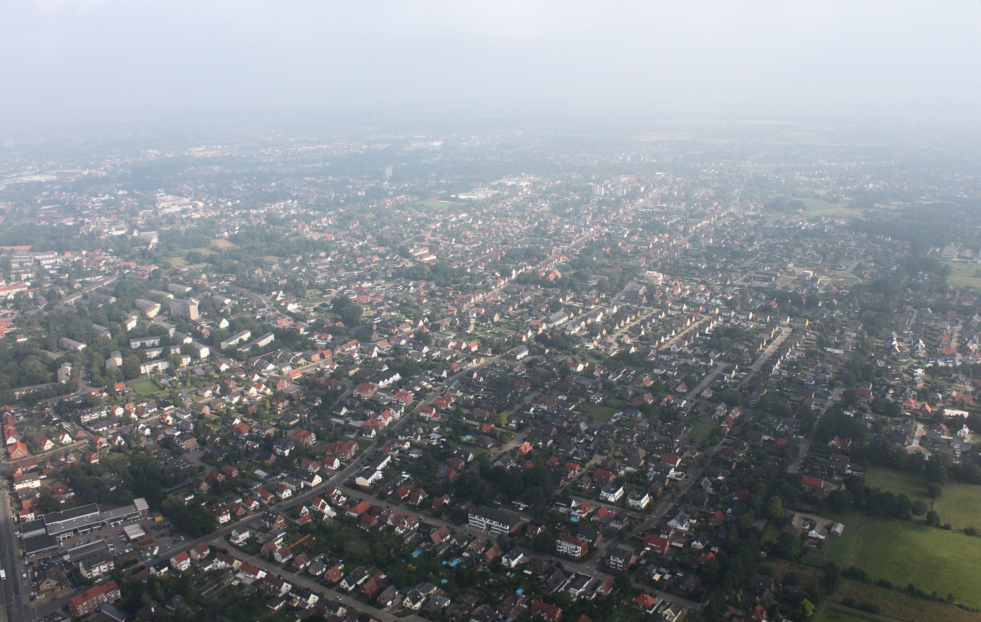 An aerial view of a densely populated urban area with numerous buildings and streets.