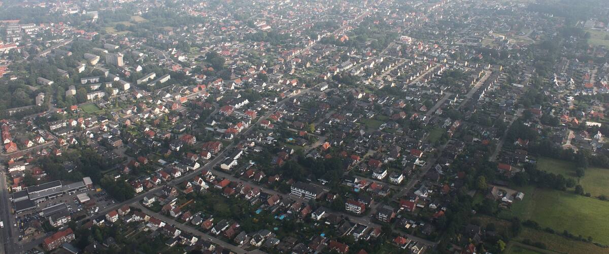 An aerial view of a densely populated urban area with numerous buildings and streets.