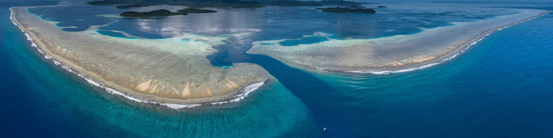 Ariel shot of small boat at coral reef, Kepidauen Mwand, pohnpei, Micronesia