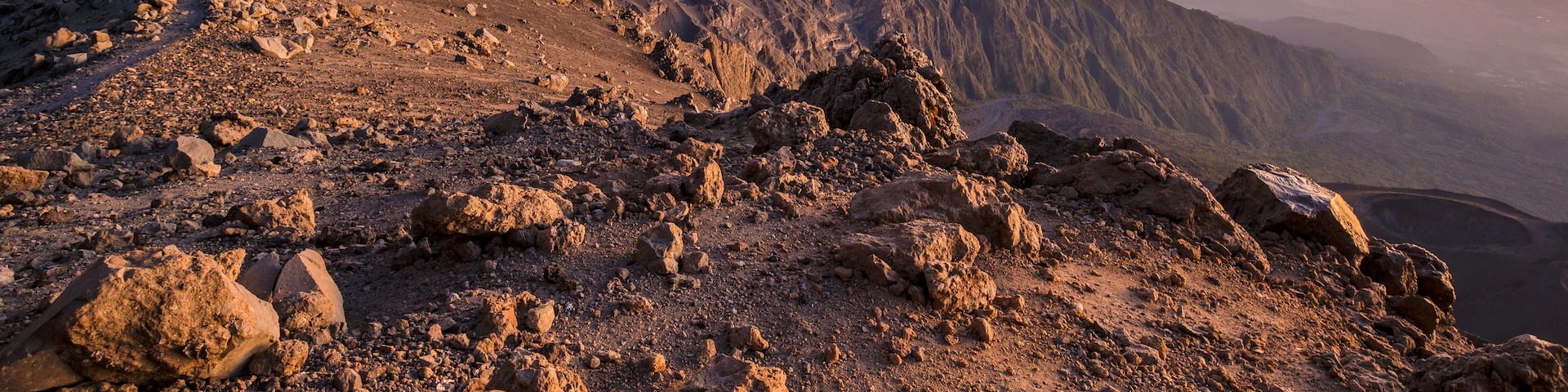 A rugged mountain landscape with rocky terrain and a clear sky.