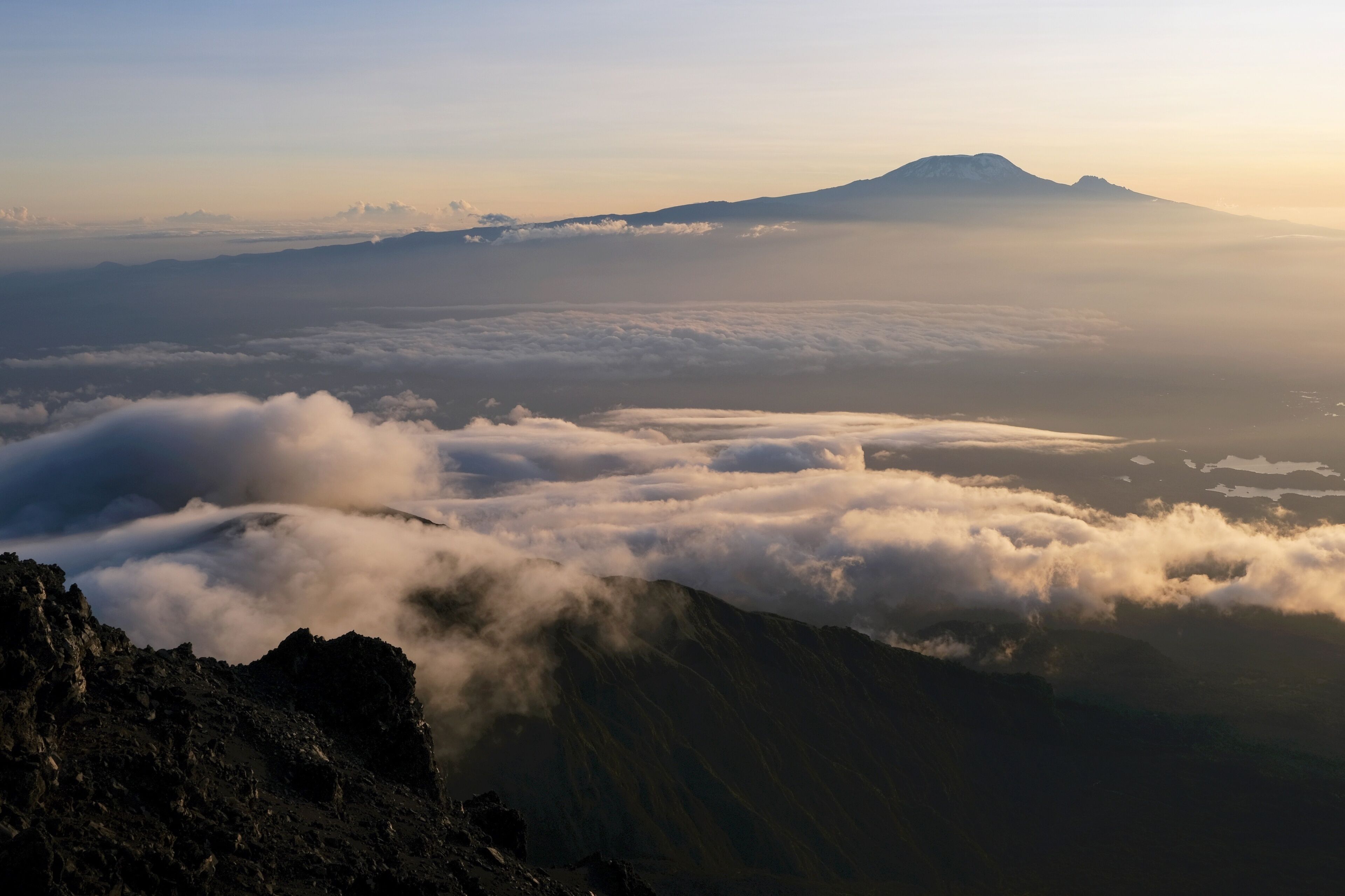 View of Kilimanjaro at sunrise while trekking Mount Meru, a volcano in Tanzania. Arusha National Park