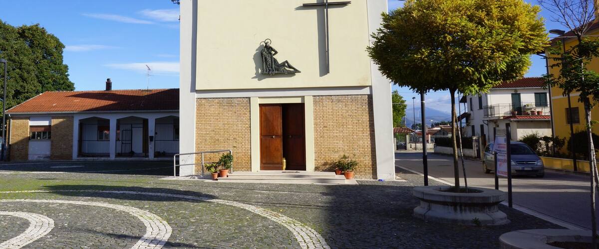 A church with a cross and a statue of Jesus Christ.