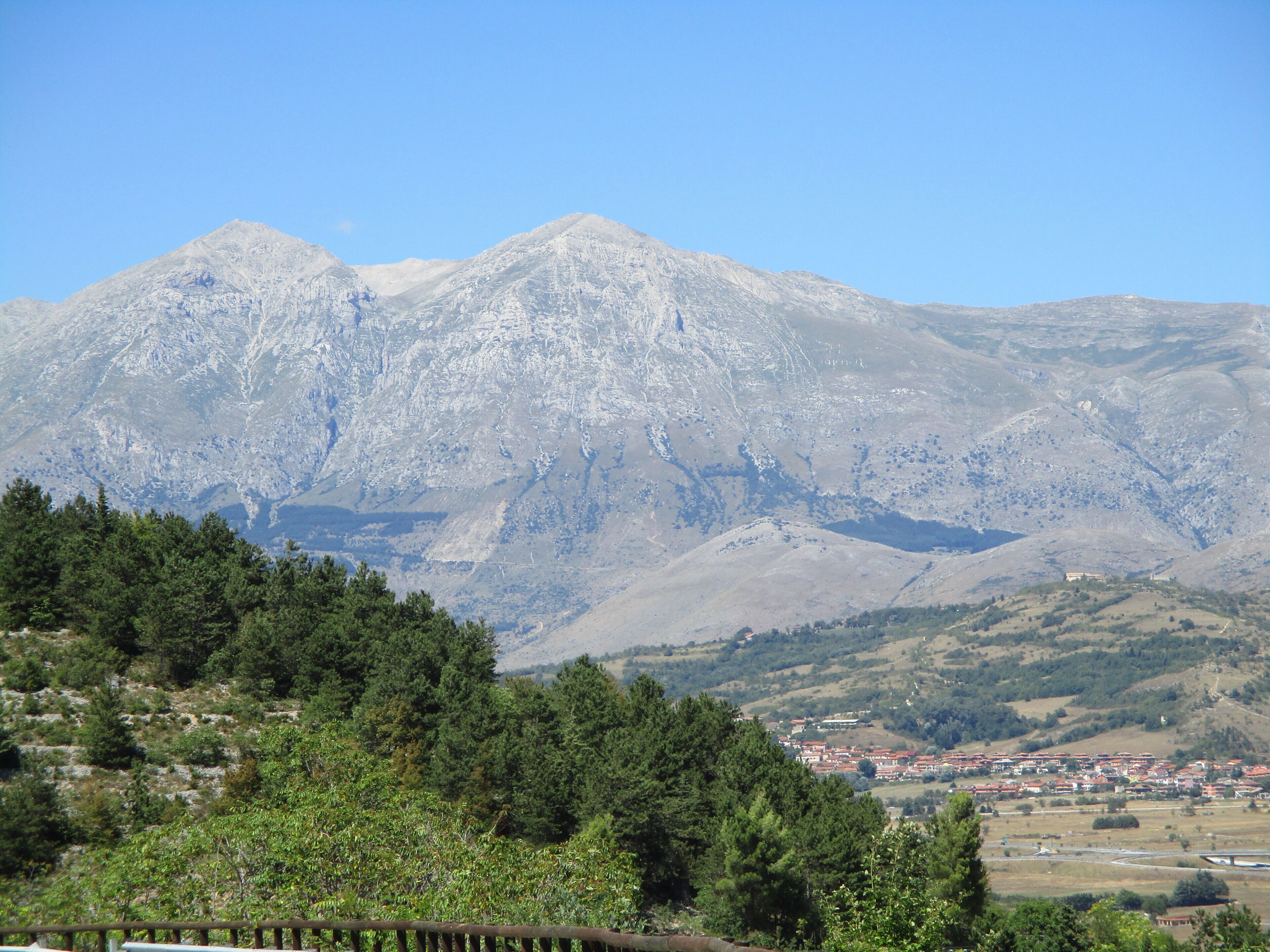 A mountain range with a town in the foreground.