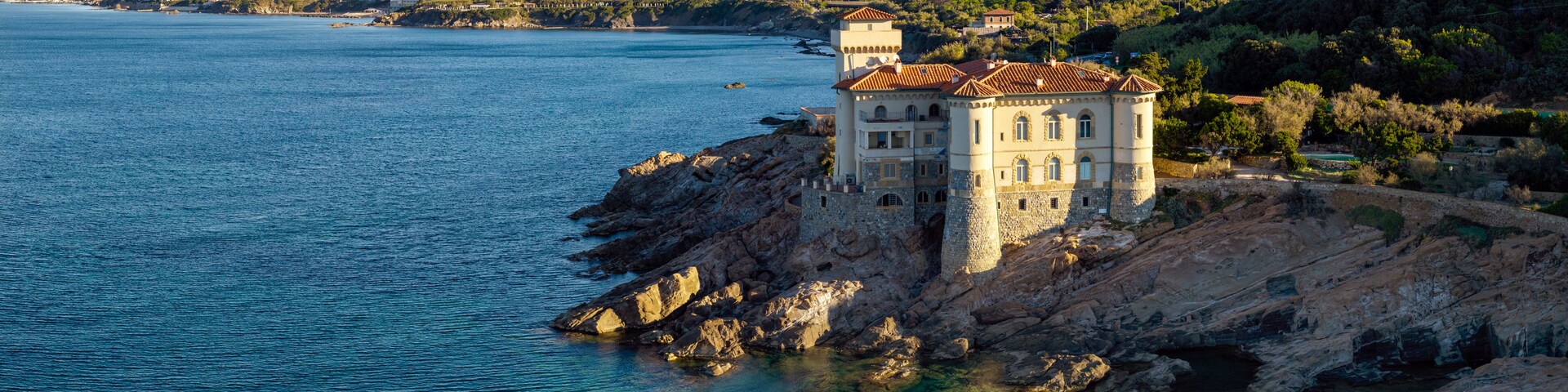 Panoramic Aerial View of Castello del Boccale at Sunrise: Medieval Castle on the Rocky Cliffs of Livorno Coast, Tuscany Italy