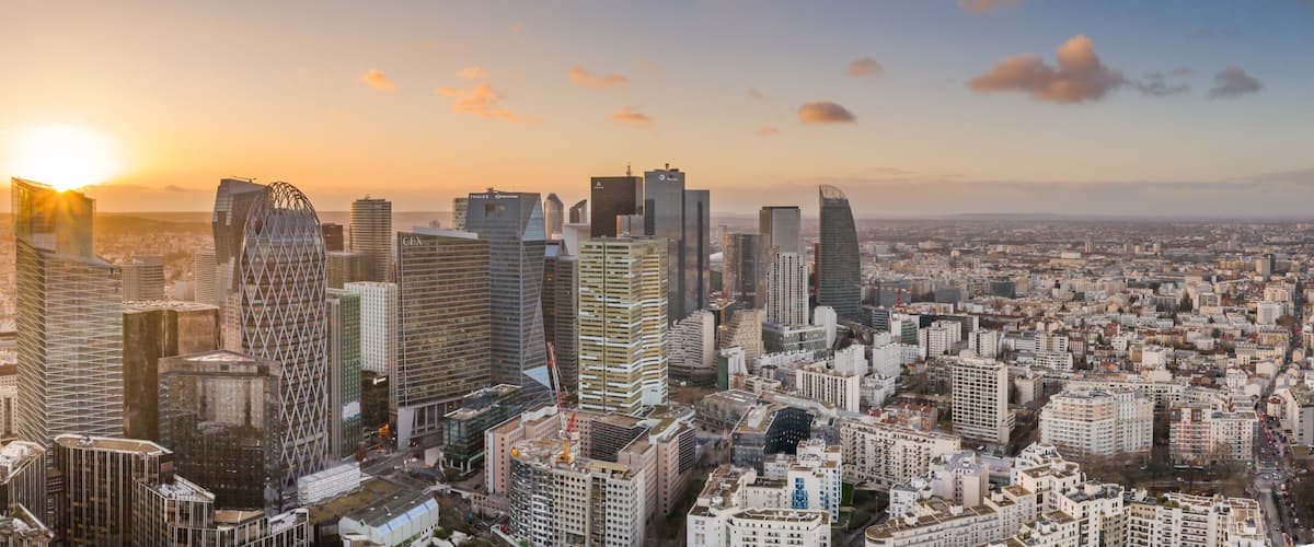 Aerial pano drone shot of La Defense skyscraper complex during sunset hours