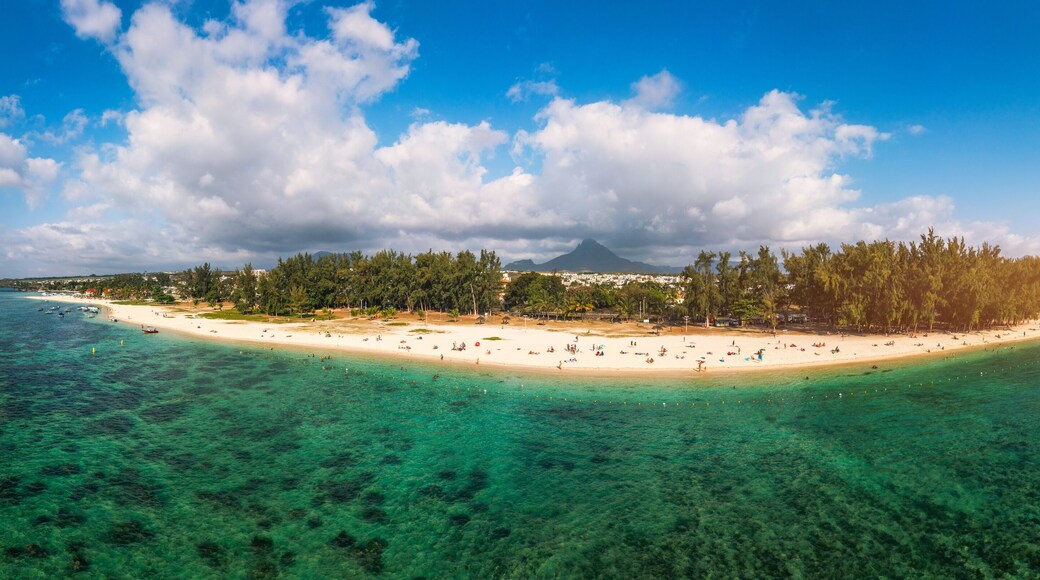 Beautiful Mauritius Island with gorgeous beach Flic en Flac, aerial view from drone. Mauritius, Black River, Flic-en-Flac view of oceanside village beach and luxurious hotel in summer.