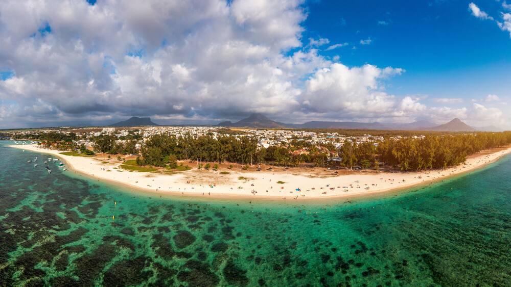 Beautiful Mauritius Island with gorgeous beach Flic en Flac, aerial view from drone. Mauritius, Black River, Flic-en-Flac view of oceanside village beach and luxurious hotel in summer.