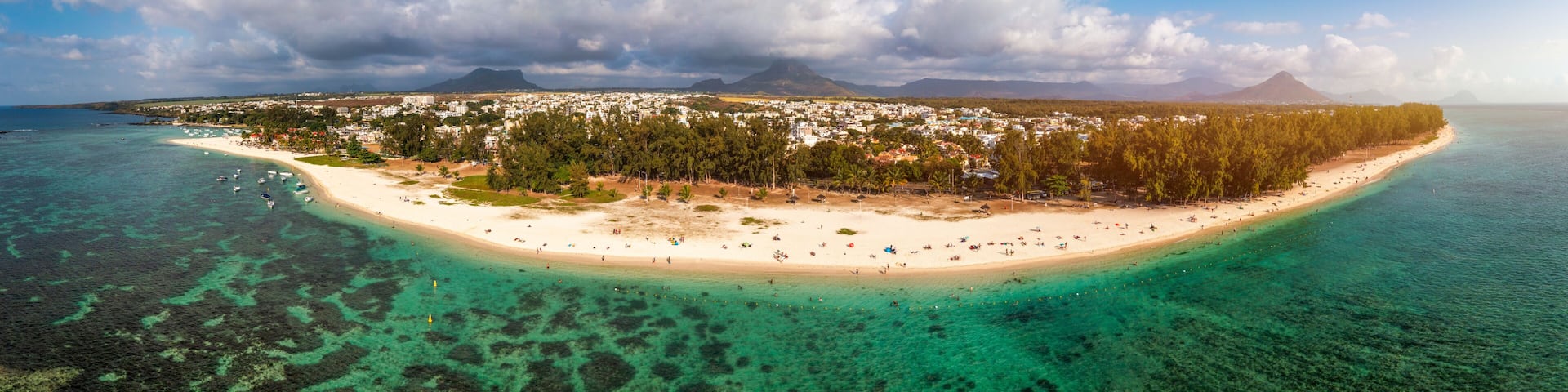 Beautiful Mauritius Island with gorgeous beach Flic en Flac, aerial view from drone. Mauritius, Black River, Flic-en-Flac view of oceanside village beach and luxurious hotel in summer.