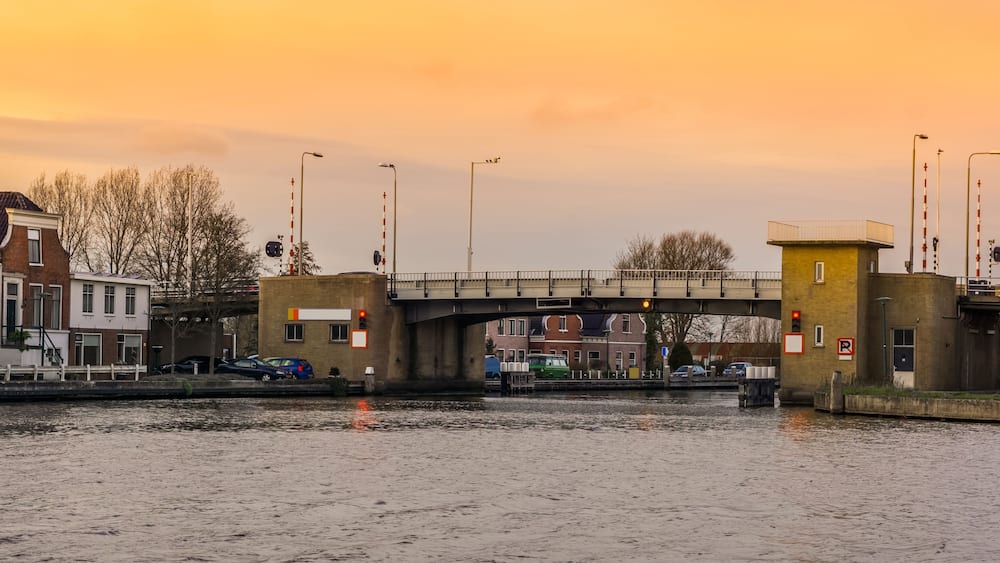 A bridge over a canal with buildings on either side.