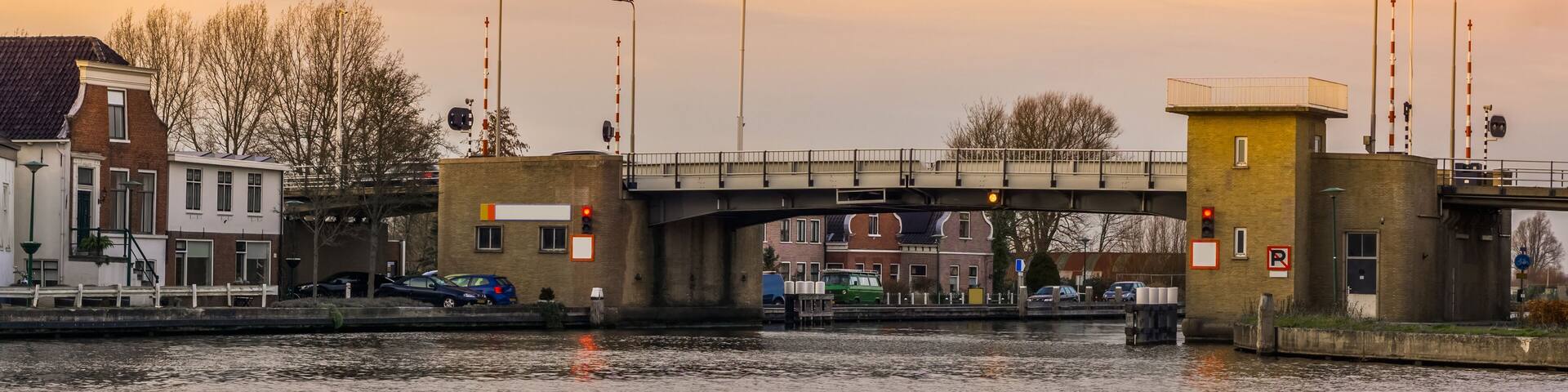 Bridge with water at sunset, molenaarsbrug of alphen aan den rijn, The netherlands, Dutch city architecture