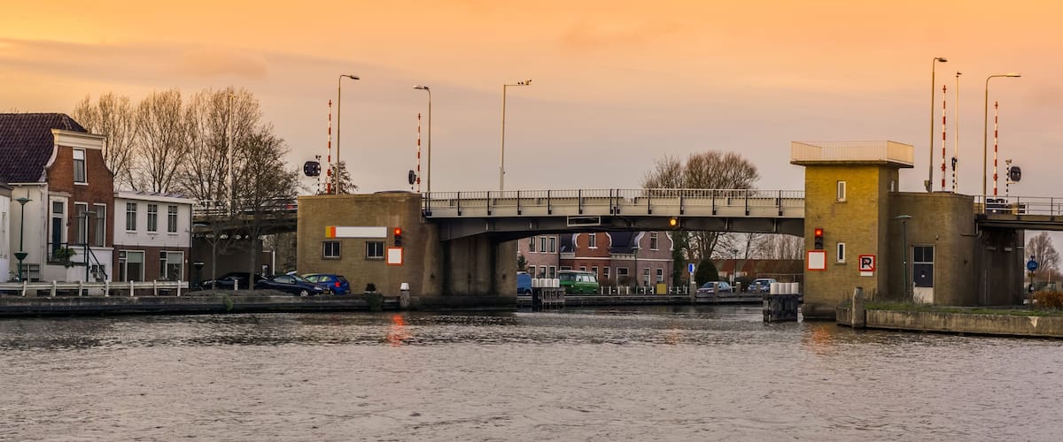 A bridge over a canal with buildings on either side.