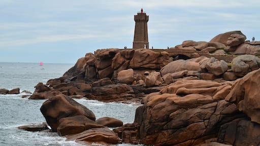 The lightouse sitting on the pink granite rock formation in Perros-Guirec in Brittany Northern France.