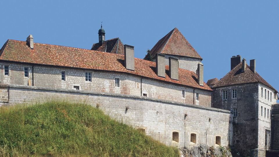 A historic stone castle with multiple towers and a fortified wall.
