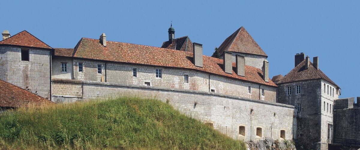 A historic stone castle with multiple towers and a fortified wall.