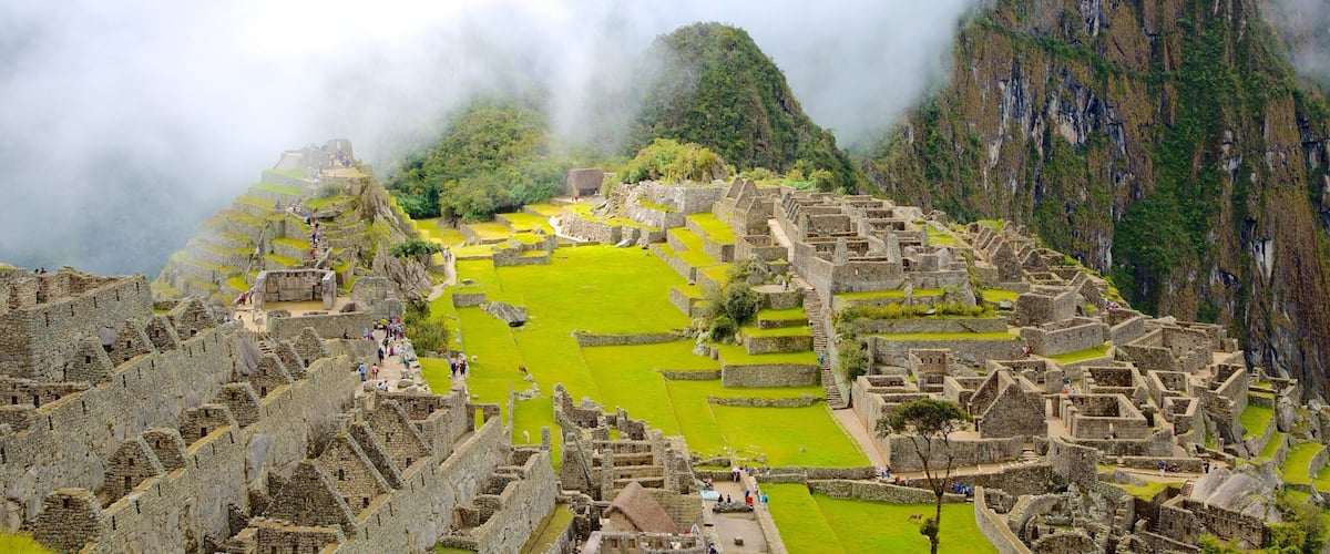 The ancient Incan ruins of Machu Picchu with terraced fields and steep mountain backdrop.