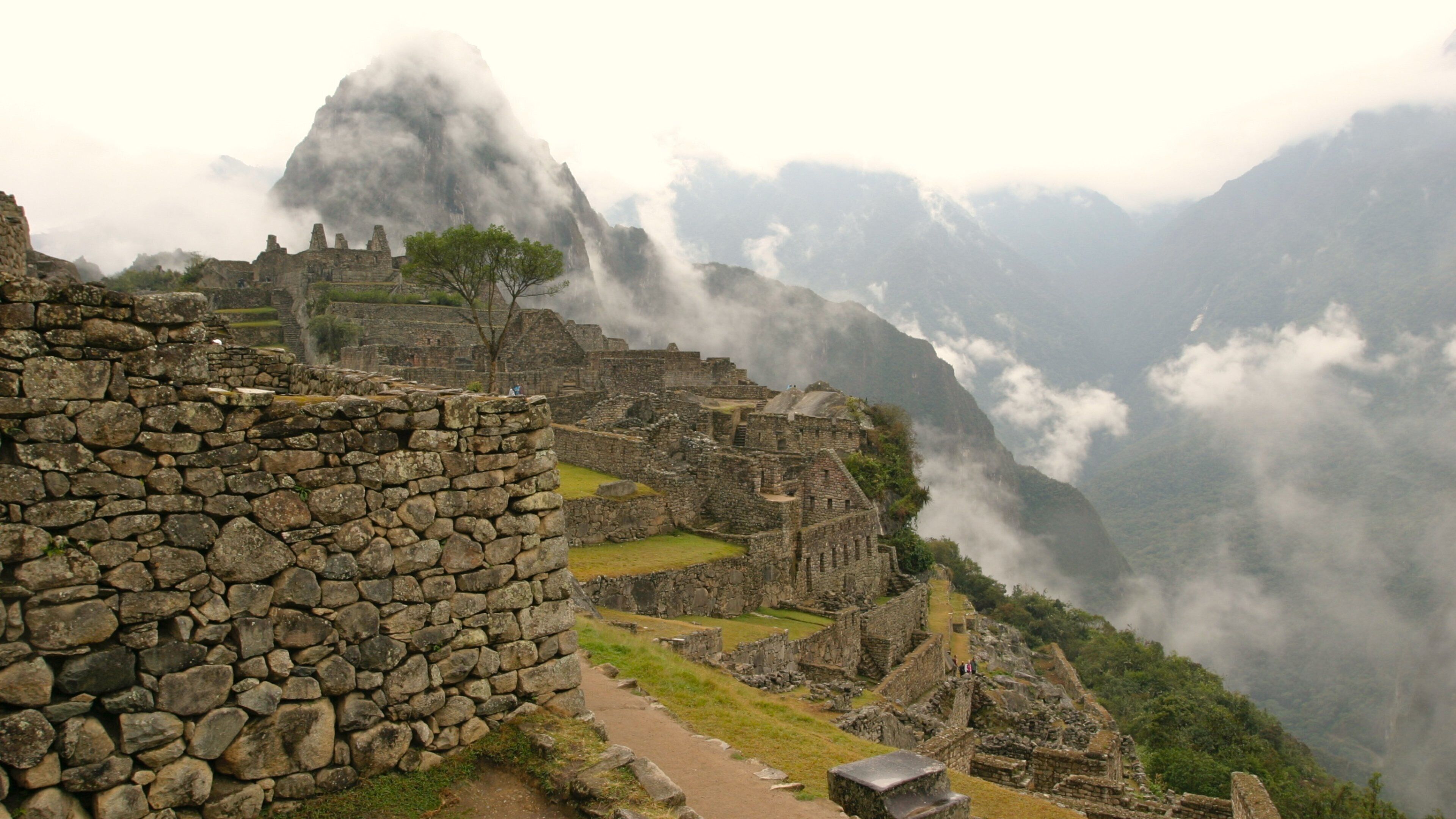 Machu Picchu showing mist or fog, mountains and building ruins