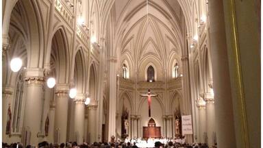 A large cathedral interior with high vaulted ceilings and multiple arches.