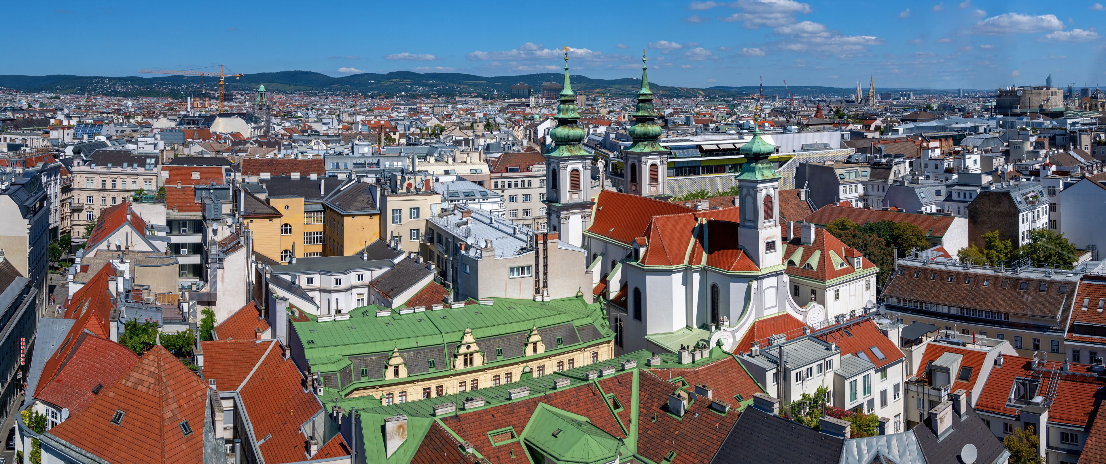 panoramic view from the former flaktower (now House of the sea) north-west across the roofs of the 6th viennese district Mariahilf with the Mariahilf church until the mountains of the Viennese woods