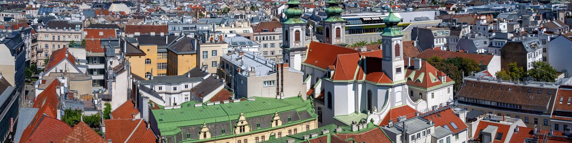 panoramic view from the former flaktower (now House of the sea) north-west across the roofs of the 6th viennese district Mariahilf with the Mariahilf church until the mountains of the Viennese woods