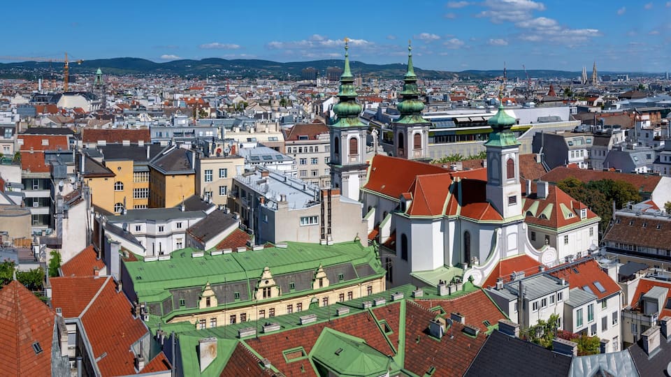 panoramic view from the former flaktower (now House of the sea) north-west across the roofs of the 6th viennese district Mariahilf with the Mariahilf church until the mountains of the Viennese woods