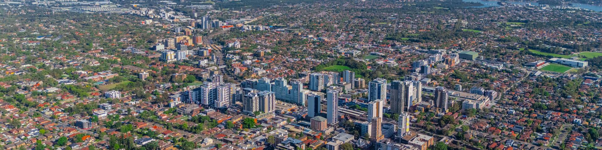 A cityscape with dense urban development, including high-rise buildings and a mix of residential and commercial structures.