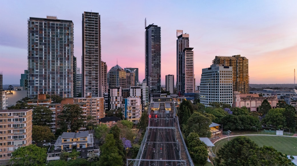 Low aerial drone of Chatswood CBD in Northern Sydney, NSW Australia looking toward the south side of the city centre during early morning at dusk in November 2024