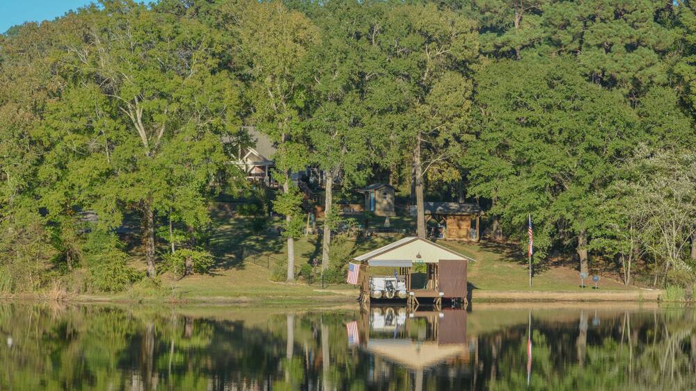 Mirror Image on Lake Cherokee of boat houses and trees. In East Henderson, Rusk County, Texas