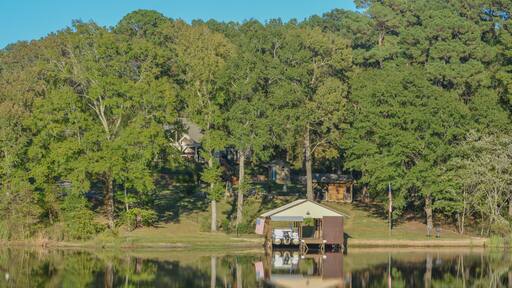 Mirror Image on Lake Cherokee of boat houses and trees. In East Henderson, Rusk County, Texas