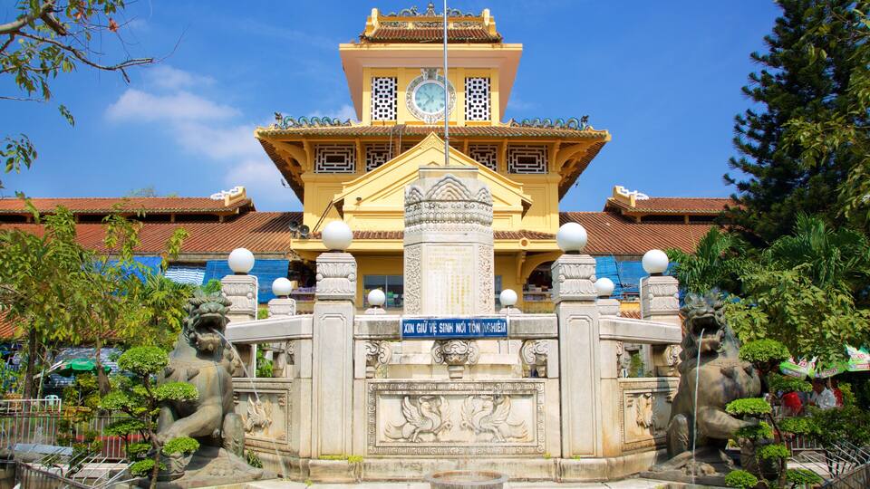 A traditional building with a clock tower, ornate carvings, and statues.