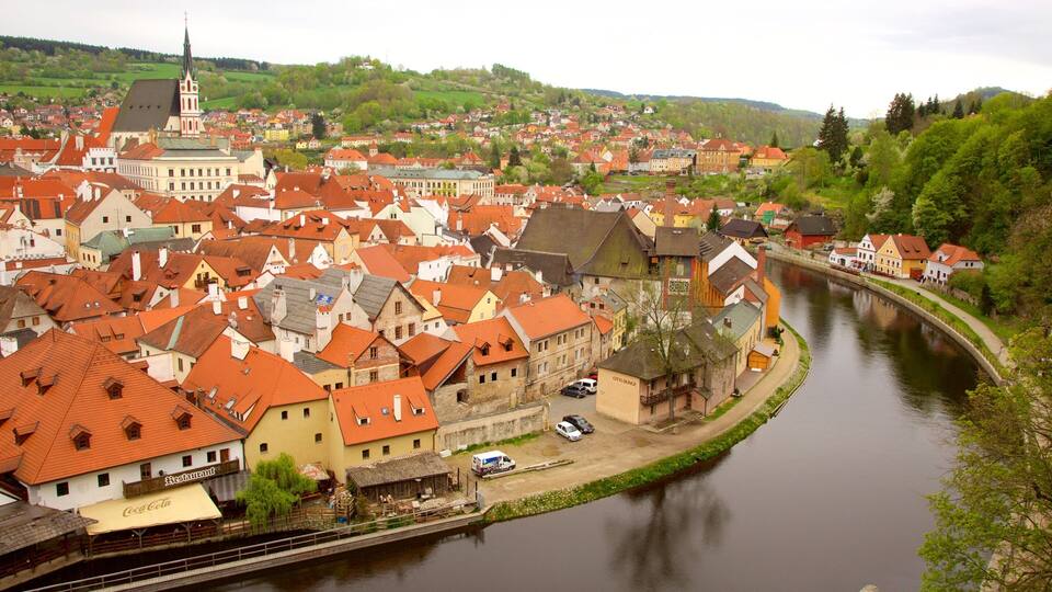 A riverside town with historic buildings and a church steeple.