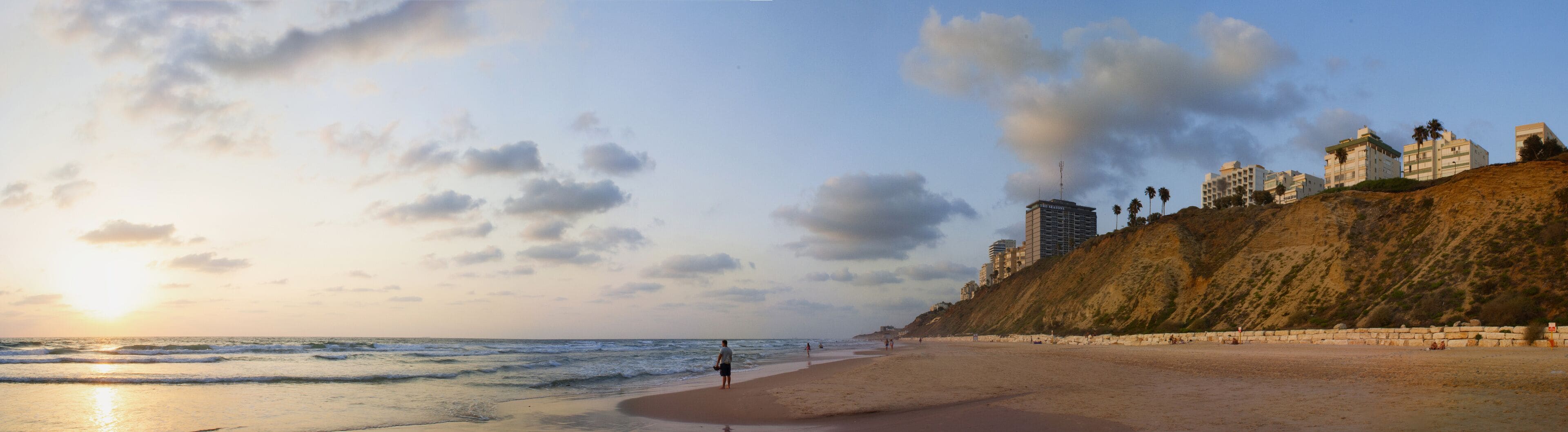 The man looks at the sunset on the sea coast